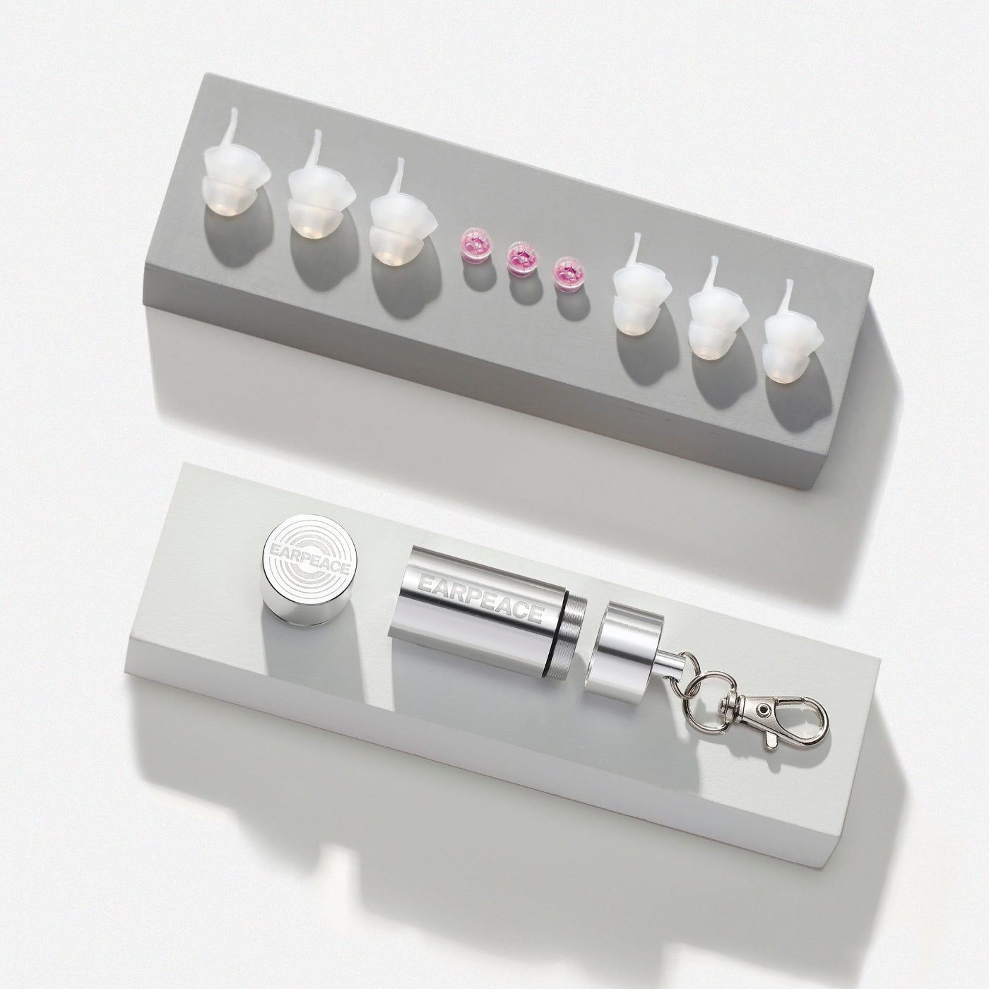 Set of earrings with a gray case on a white background