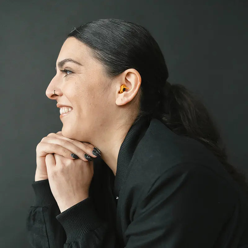side view of model wearing Earpeace Adventure PRO earplugs
