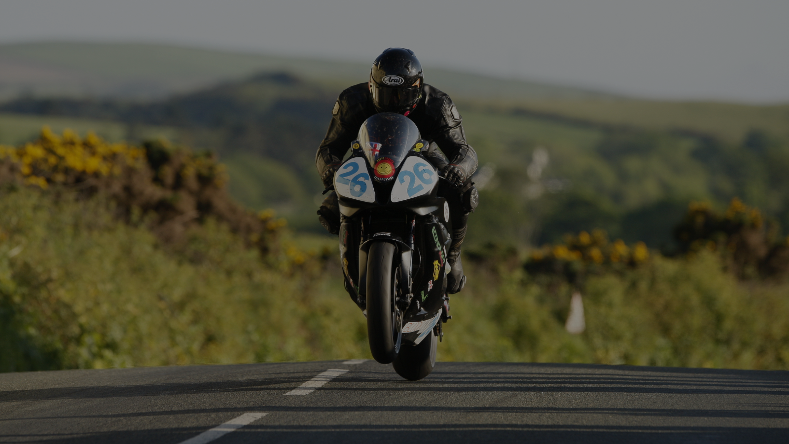 man on motorcycle country road