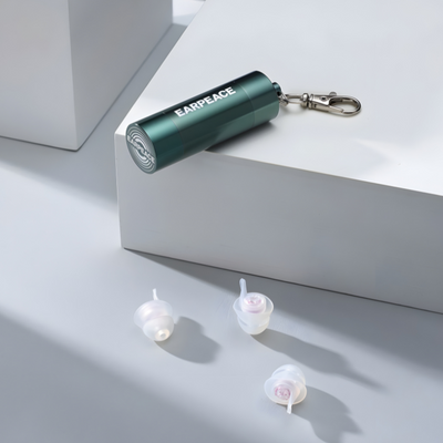 a green case with a set of clear earplugs on risers