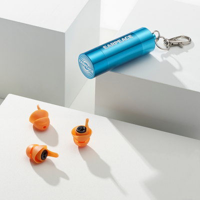 Orange earplugs and blue carrying case with 'EARPEACE' branding on a white surface.