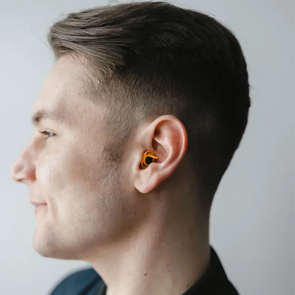 side view of male model wearing Adventure PRO earplugs